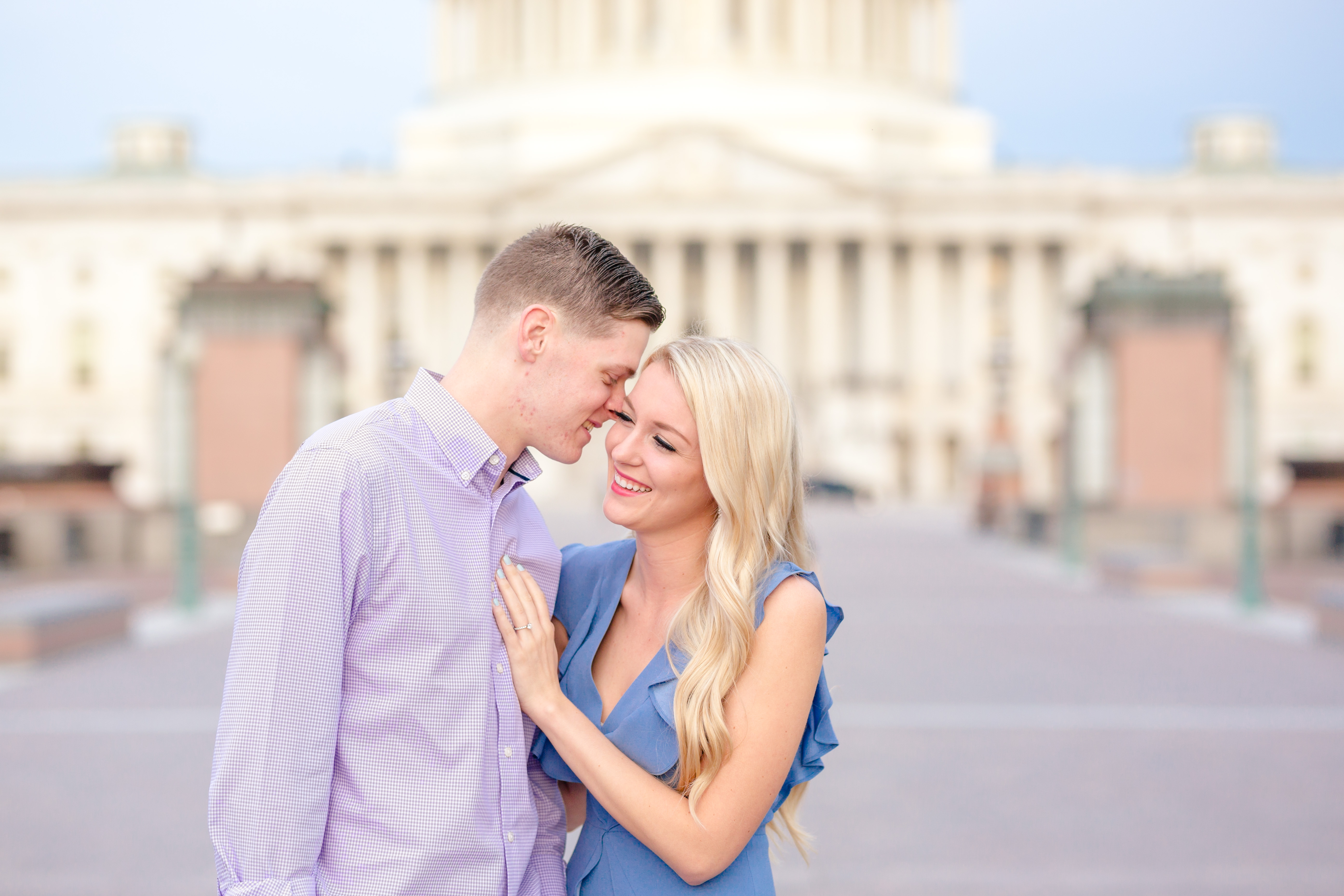 couple nuzzling in front of capitol