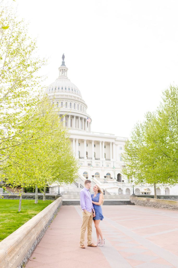 couple nuzzling in front of capitol building