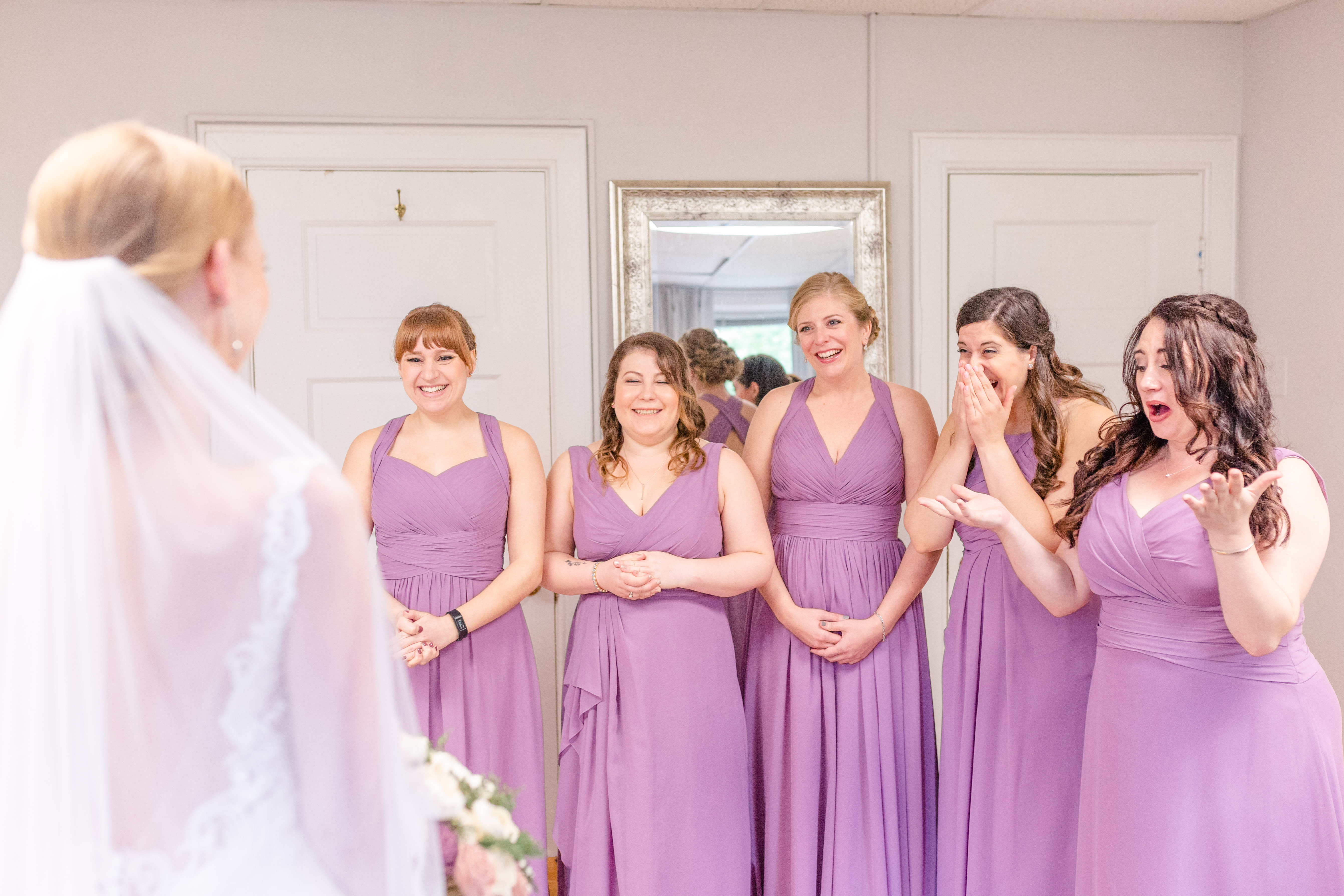 bridesmaids seeing bride for the first time, very excited