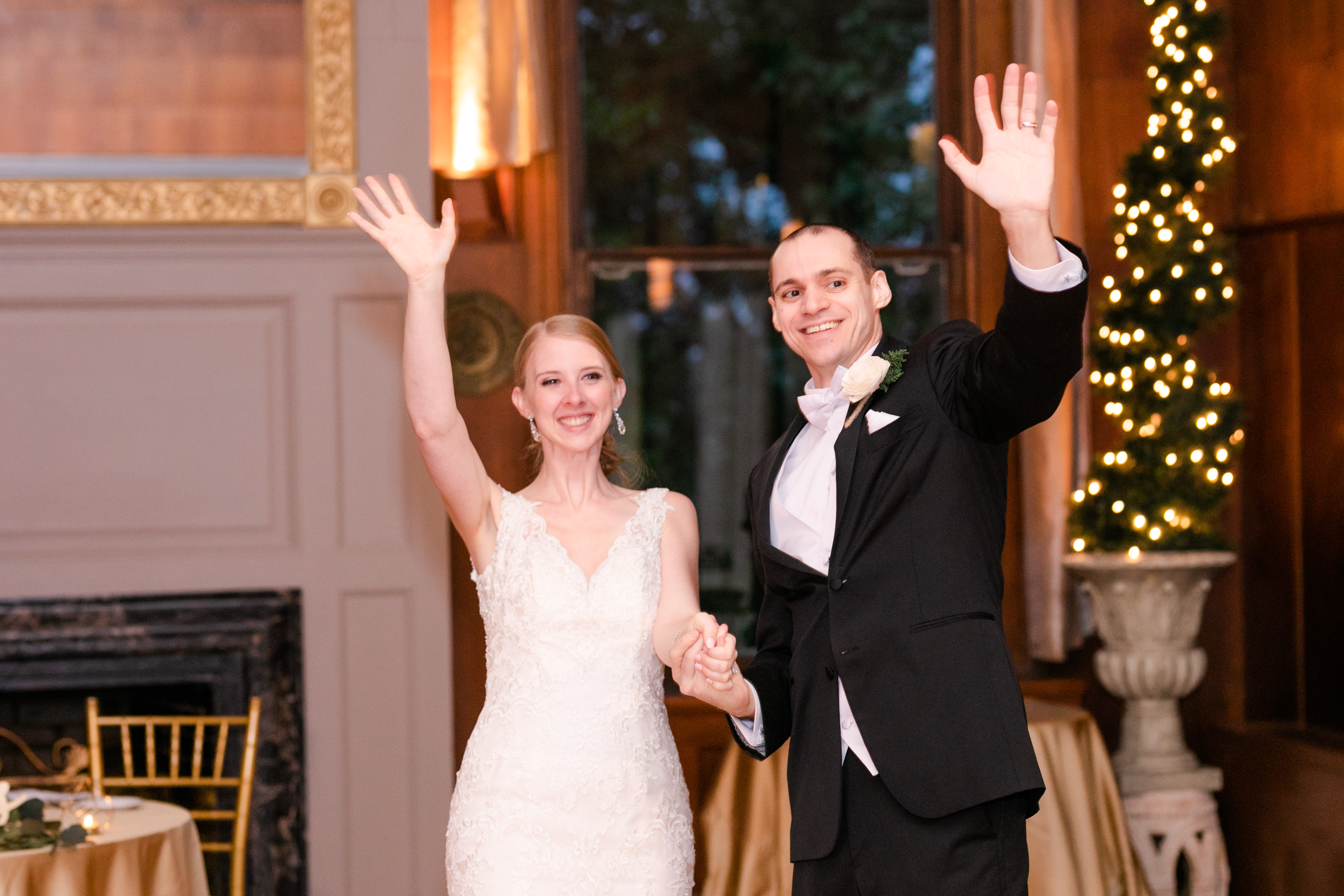 bride and groom waving at crowd