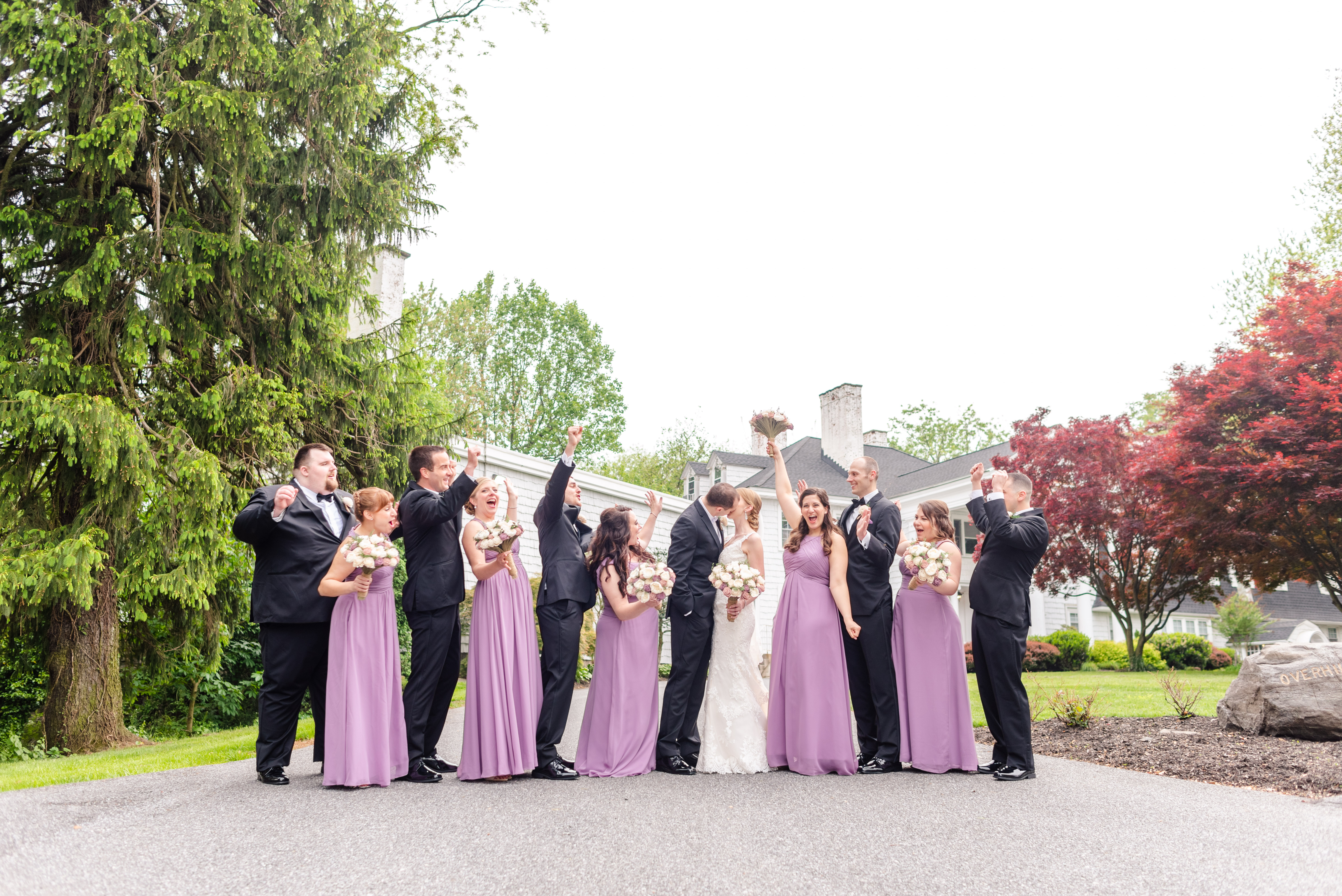 bridal party excited that bride and groom are kissing