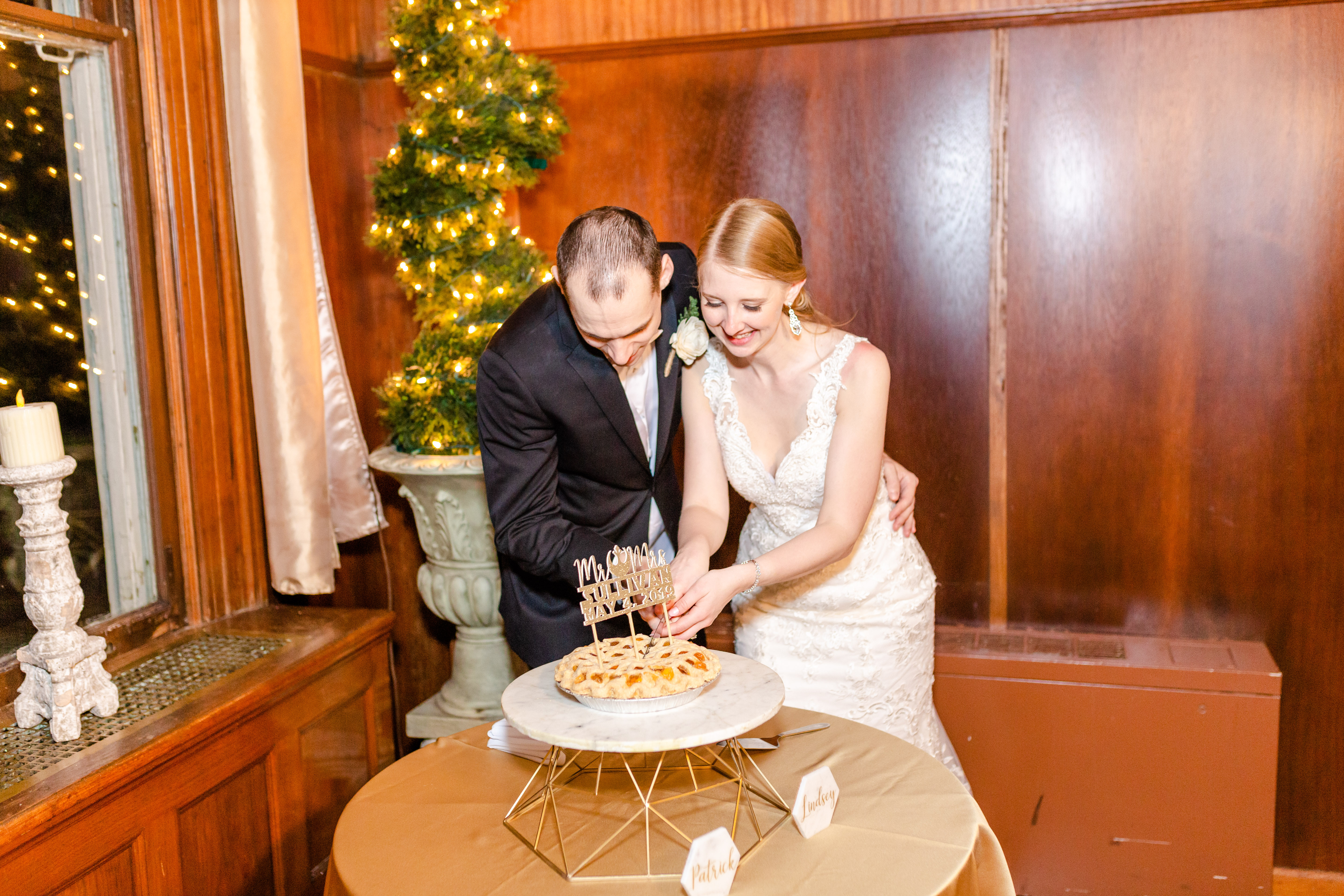 bride and groom cutting pie