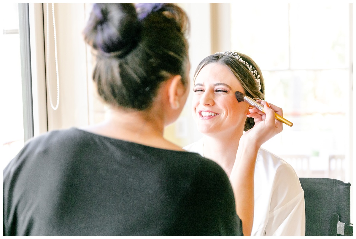 bride getting make up done by lashes and lace